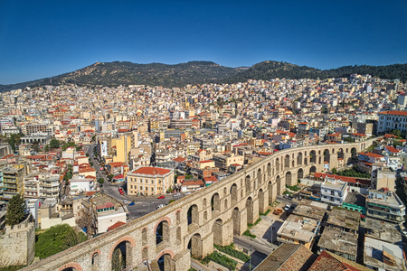 Aerial view the city of Kavala in northern Greek, ancient aqueduct Kamares, homes and medieval city wall の写真素材