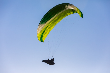 Drama, Greece -  April 8, 2018: Paragliders fly against blue sky in the popular area for parachuting on the side of Korylovos in Dramaのeditorial素材