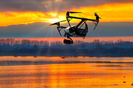 Modern drone watching the beautiful sunset の写真素材