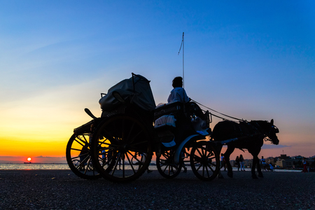horse carriage ride at sunsetの写真素材