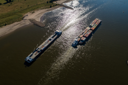 Rhine - Netherlands, July 14, 2018: aerial view of a merchant ship with a container crossing the river Rhine in a region of the Netherlandsのeditorial素材