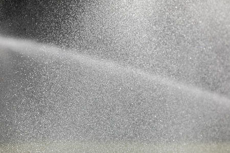 Sprinkler system working on fresh green grass on football (soccer) stadiumの写真素材