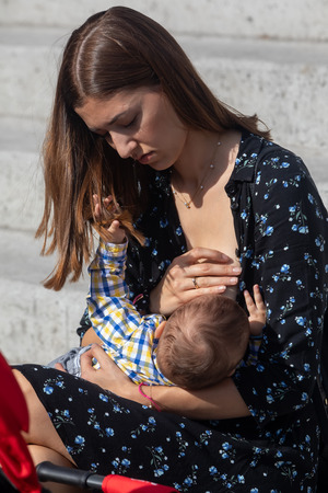Thessaloniki, Greece - November 4, 2018: Mother breastfeeding her baby on the 9th Nationwide public breastfeeding in celebration of World Breastfeeding Weekのeditorial素材
