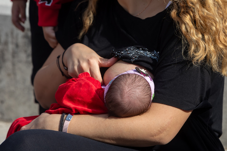 Thessaloniki, Greece - November 4, 2018: Mother breastfeeding her baby on the 9th Nationwide public breastfeeding in celebration of World Breastfeeding Weekのeditorial素材