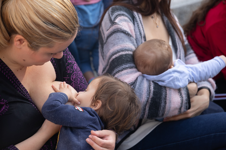 Thessaloniki, Greece - November 4, 2018: Mother breastfeeding her baby on the 9th Nationwide public...