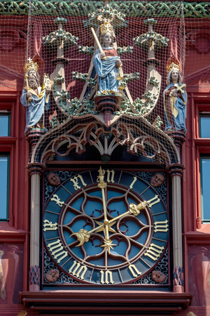 The beautiful decorated old City Hall of Basel in Swiss - the clock at the facade of the buildingのeditorial素材