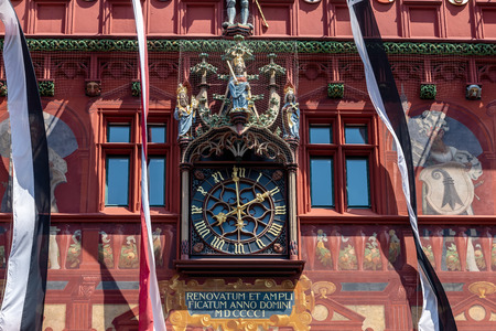 The beautiful decorated old City Hall of Basel in Swiss - the clock at the facade of the building