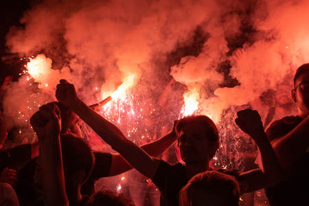 Thessaloniki, Greece - September 22, 2018: Music fans burn fire torch on wild rock concert at the open theater of the city of Thessaloniki. Crowd on festival.Dangerous flammable fireworksのeditorial素材