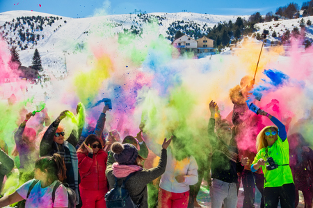Seli, Greece - February 17, 2019: Crowds of unidentified people throw colour powderduring the annual winter event "Day of Colours" in the snowy landscapeのeditorial素材