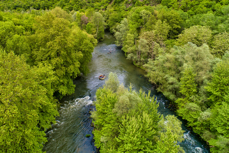 Paranesti, Drama, Greece - May 1, 2019: Aerial view of adventure team doing rafting on the cold waters of the Nestos River in Paranesti. Nestos river is one of the most popular among rafters in Greeceのeditorial素材