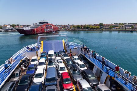 Thassos, Greece - July 20, 2019: Big ferry boat deck with passengers and cars, runs from Keramoti...