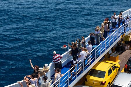 Thassos, Greece - July 20, 2019: Big ferry boat deck with passengers and cars, runs from Keramoti city to Thassos island.のeditorial素材