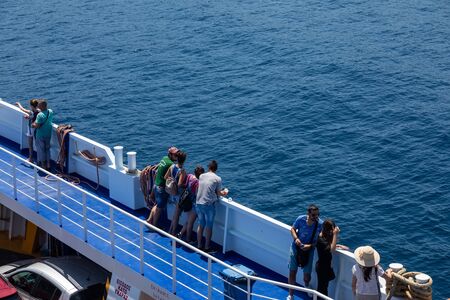 Thassos, Greece - July 20, 2019: Big ferry boat deck with passengers and cars, runs from Keramoti...
