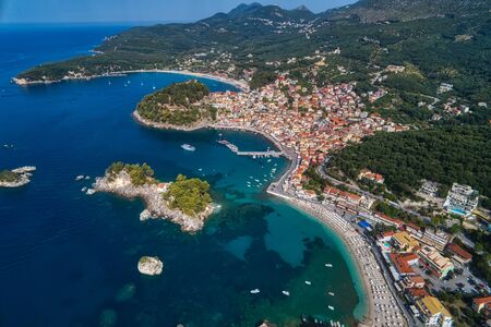 Aerial cityscape view of the coastal city of Parga, Greece during the Summer. Crystal water natural landscape and beautiful architectural buildings near the port of Parga Epirus, Greece, Europe.の写真素材