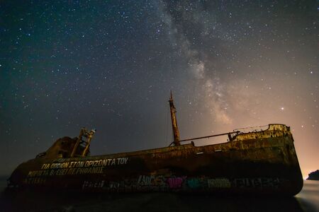 Gythio, Greece - August 1, 2019: The Milky Way above the Dimitrios shipwreck in Gythio in the...