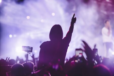 People taking photographs with touch smart phone during a music entertainment public concert.  live concert, music festival, happy youth, luxury party, landscape exterior. Selctive Focusの写真素材