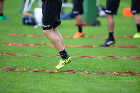 Horst, Netherlands - June 24, 2018: The feet of PAOK players and football training equipment during the training of the team on the pitchのeditorial素材