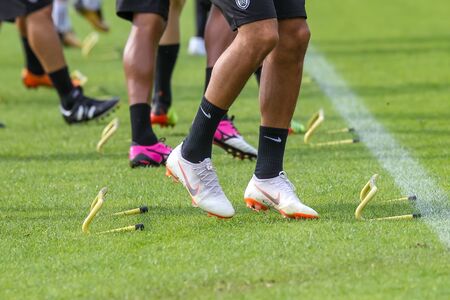 Horst, Netherlands - June 27, 2018: The feet of PAOK players and football training equipment during the training of the team on the pitchのeditorial素材