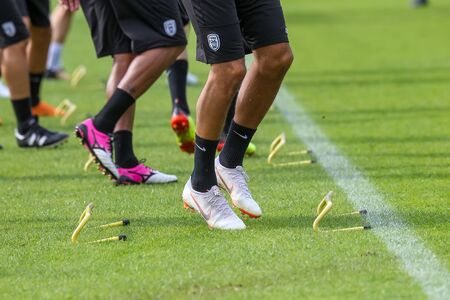 Horst, Netherlands - June 27, 2018: The feet of PAOK players and football training equipment during...