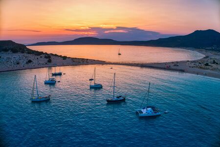 Aerial view of Simos beach at sunset in Elafonisos island in Greece. Elafonisos is a small Greek island the Peloponnese with idyllic exotic beaches and crystal clear waters. Laconia, Greece, Europeの写真素材
