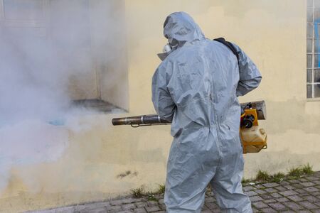 Thessaloniki, Greece - Feb 28, 2020: Workers sprays disinfectant as part of preventive measures against the spread of the COVID-19, the novel coronavirus, in a schoolのeditorial素材