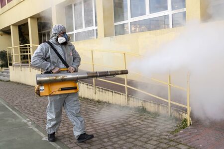 Thessaloniki, Greece - Feb 28, 2020: Workers sprays disinfectant as part of preventive measures against the spread of the COVID-19, the novel coronavirus, in a schoolのeditorial素材