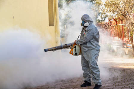 Thessaloniki, Greece - Feb 28, 2020: Workers sprays disinfectant as part of preventive measures against the spread of the COVID-19, the novel coronavirus, in a schoolのeditorial素材