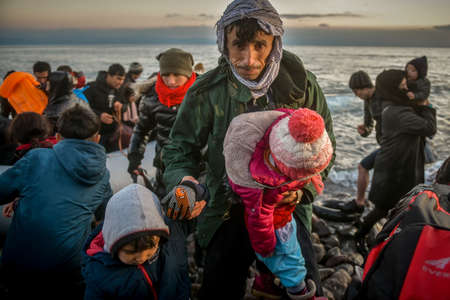 Lesbos, Greece, March 2, 2020: Refugees and Migrants aboard reach the Greek Island of Lesbos after crossing on a dinghy the Aegean sea from Turkeyのeditorial素材