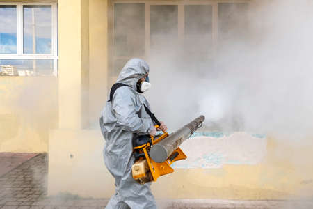 Thessaloniki, Greece - Feb 28, 2020: Workers sprays disinfectant as part of preventive measures against the spread of the COVID-19, the novel coronavirus, in a schoolのeditorial素材