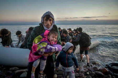 Lesbos, Greece, March 2, 2020: Refugees and Migrants aboard reach the Greek Island of Lesbos after crossing on a dinghy the Aegean sea from Turkeyのeditorial素材