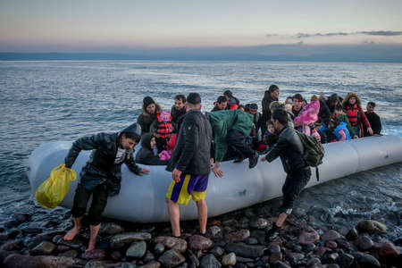 Lesbos, Greece, March 2, 2020: Refugees and Migrants aboard reach the Greek Island of Lesbos after crossing on a dinghy the Aegean sea from Turkeyのeditorial素材