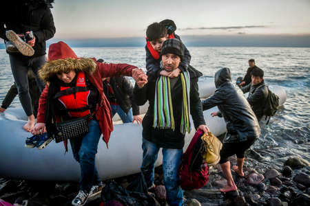 Lesbos, Greece, March 2, 2020: Refugees and Migrants aboard reach the Greek Island of Lesbos after crossing on a dinghy the Aegean sea from Turkeyのeditorial素材