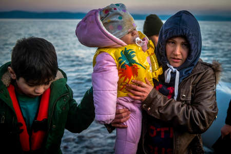 Lesbos, Greece, March 2, 2020: Refugees and Migrants aboard reach the Greek Island of Lesbos after crossing on a dinghy the Aegean sea from Turkeyのeditorial素材