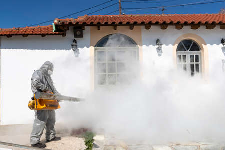 Thessaloniki, Greece - March 12, 2020: Workers sprays disinfectant as part of preventive measures against the spread of the coronavirus (COVID-19), the novel coronavirus, in a churchのeditorial素材
