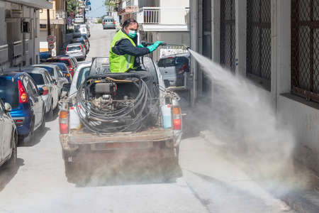 Thessaloniki, Greece - April 8, 2020: Workers sprays disinfectant as part of preventive measures against the spread of the COVID-19, the novel coronavirus, in a streets and squaresのeditorial素材