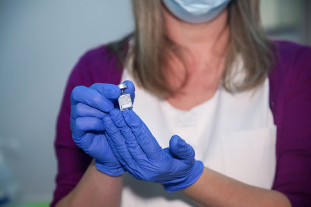 Thessaloniki, Greece - Decemper 29, 2020: A nurse holds a vial of the Pfizer-BioNTech coronavirus disease (COVID-19) vaccine at AHEPA hospital, as the country starts its national vaccinationのeditorial素材