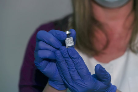 Thessaloniki, Greece - Decemper 29, 2020: A nurse holds a vial of the Pfizer-BioNTech coronavirus disease (COVID-19) vaccine at AHEPA hospital, as the country starts its national vaccinationのeditorial素材