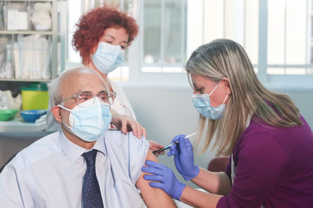 Thessaloniki, Greece - Decemper 29, 2020: member of the medical staff receives a dose of the Pfizer-BioNTech Covid-19 vaccineat the AHEPA hospital in Thessaloniki, as the country starts its national vaccinationのeditorial素材