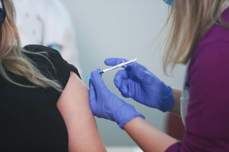 Thessaloniki, Greece - Decemper 29, 2020: member of the medical staff receives a dose of the Pfizer-BioNTech Covid-19 vaccineat the AHEPA hospital in Thessaloniki, as the country starts its national vaccinationのeditorial素材