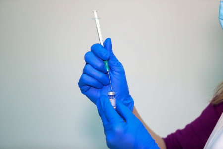 Thessaloniki, Greece - Decemper 29, 2020: A nurse prepares to administer Pfizer-BioNTech COVID-19...