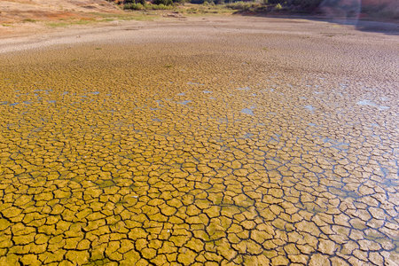 The lake at Kato Scholari, a little outside Thessaloniki, Greece, turned into a desert. The once full lake which was a habitat with many species of flora and fauna, now resembles part of a desert areaの写真素材