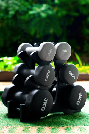 Set of six dumbbells of different size and weight outdoors の写真素材