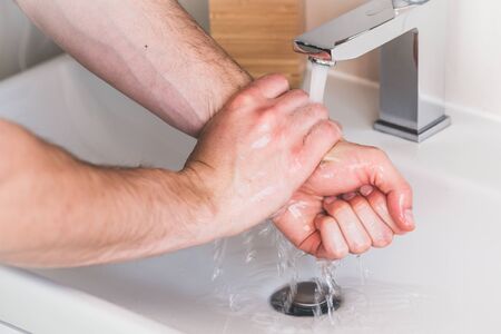Hand washing with soap in bathroom to prevent contaminate, close upの写真素材
