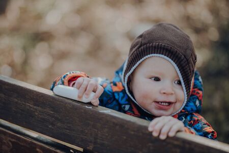 portrait of cute infant, smiles, close up, outdoorの写真素材