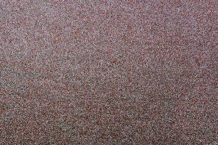 The photo shows an abstract background with a brown grainy textureの写真素材