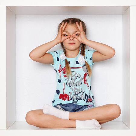 The girl is sitting in a boxの写真素材