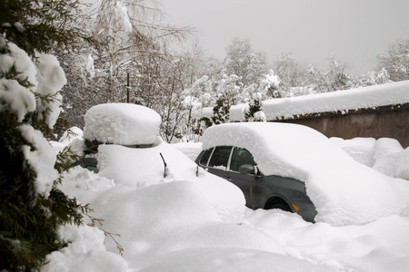 Snow covered cars in winter season, snowstormの写真素材