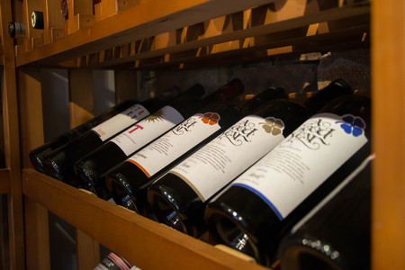Bottles of wine in the cellar, restaurant, elite drinks on shelves with written names