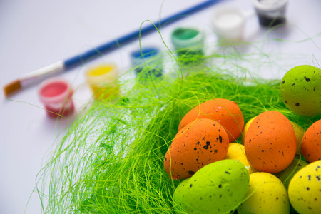 Green nest with colorful Easter eggs decoration, close-up, easter concept, holiday tradition,...