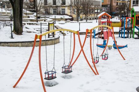 Wintertime in the city Smolyan, Bulgaria, empty children playground, toys covered in snow, playground covered in snow, sport unitsの写真素材
